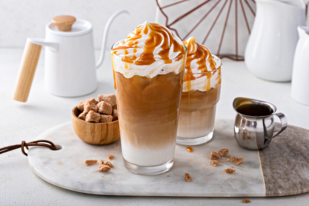 iced caramel latte topped with whipped cream and caramel sauce
